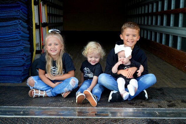 The owners of the Indianapolis moving company, Move Indy, have their kids pose for a picture on the back of the moving truck!